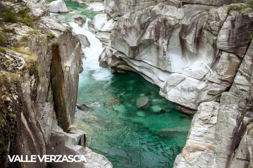 a pool of water in a river in a canyon at Locarno Center - Free Parking, Netflix and WiFi in Locarno