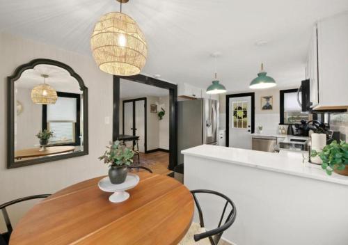 a kitchen and dining room with a wooden table and chairs at Modernized Historical Home in Downtown Medina with Hot Tub in Medina