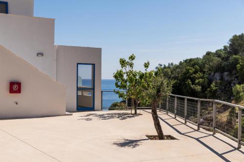 a view of the ocean from the balcony of a house at Mikro Nisi Studios & Apartments in Agios Nikolaos