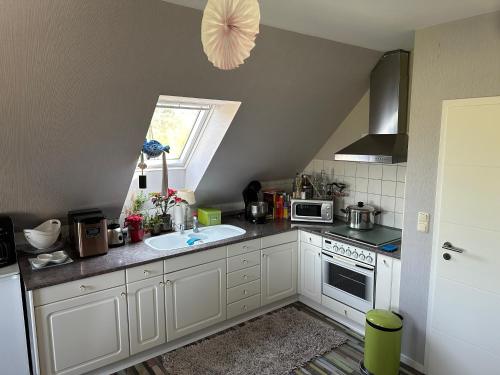 a small kitchen with a sink and a window at Ferienwohnung Rudolstadt-Festival in Rudolstadt