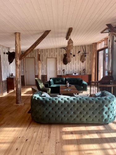 a large living room with a couch and a table at Country Lodge in Les Épasses
