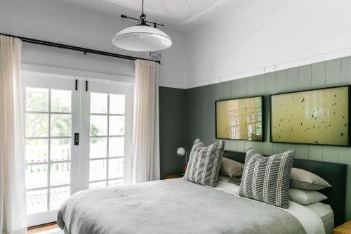a bedroom with a bed and a large window at Hide and Seek Estate, Kangaroo Valley in Upper Kangaroo River