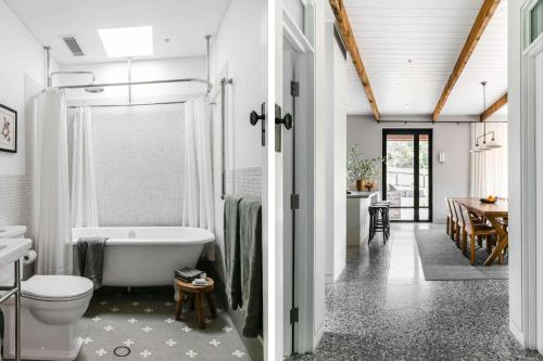 a bathroom with a tub and a toilet and a table at Hide and Seek Estate, Kangaroo Valley in Upper Kangaroo River