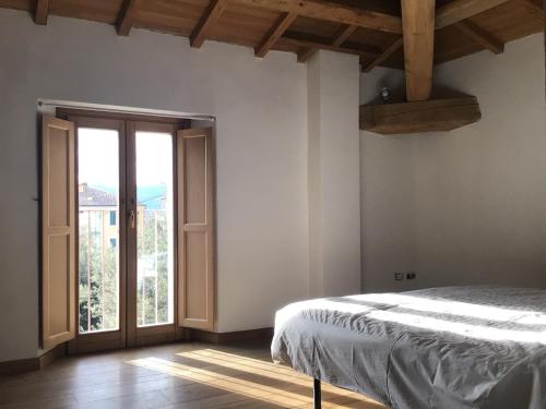 a bedroom with a bed and a large window at Casa centro storico Rieti in Rieti