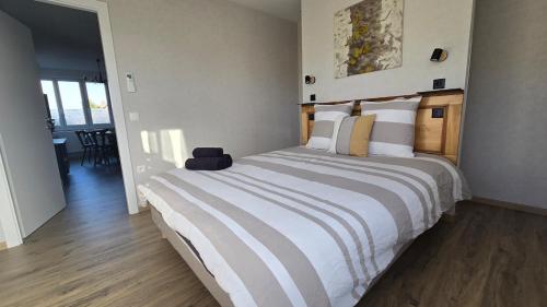 a bedroom with a large bed in a room at Côté Châteaux au Centre Alsace in Kintzheim