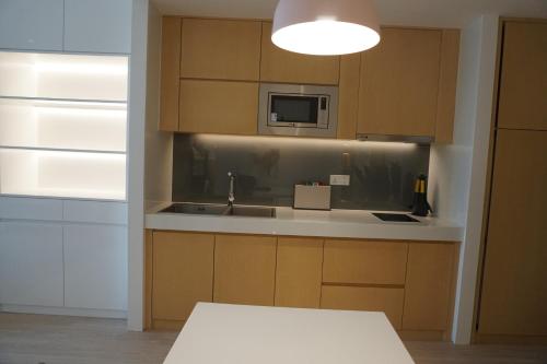 Kuchyň nebo kuchyňský kout v ubytování Zhengzhou Jianye Tianzhu International Apartment