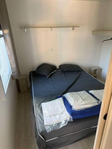 une petite chambre avec un lit dans une pièce dans l'établissement Mobil Home - Camping siblu les sables du midi - Valras Plage, à Sérignan