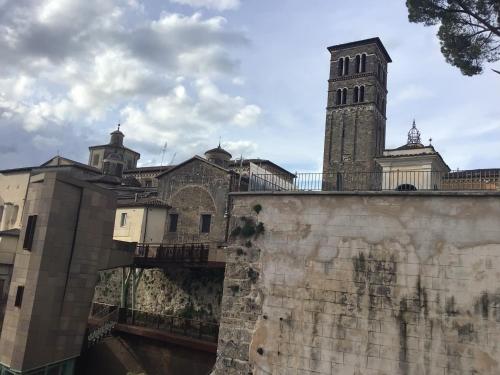 a building with a clock tower and a bridge at Casa centro storico Rieti in Rieti