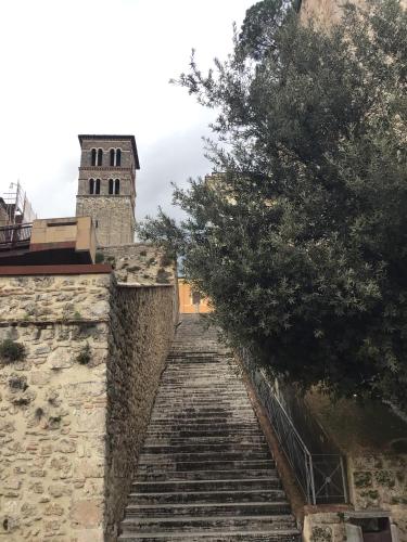 a stairway leading up to a building with a tower at Casa centro storico Rieti in Rieti