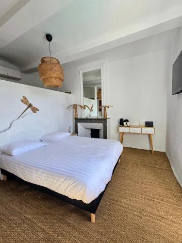 a bedroom with a large bed in a room at L'uzanges in Lussan