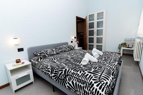 a bedroom with two beds with black and white sheets at Dolce Riviera Marina Centro in Rimini