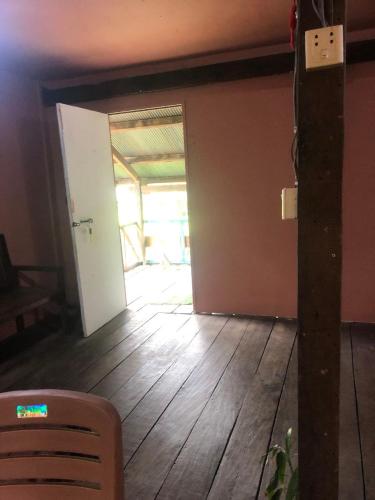 an empty room with a door and a wooden floor at Sok Phen Homestay in Siem Reap