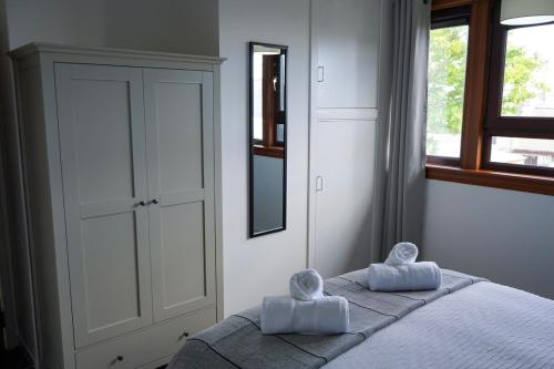 a bedroom with a bed with two towels on it at Rosehearty house - 3 bedroom in Rosehearty