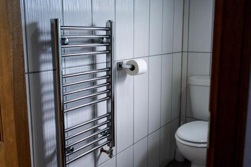 a bathroom with a toilet and a roll of toilet paper at Rosehearty house - 3 bedroom in Rosehearty