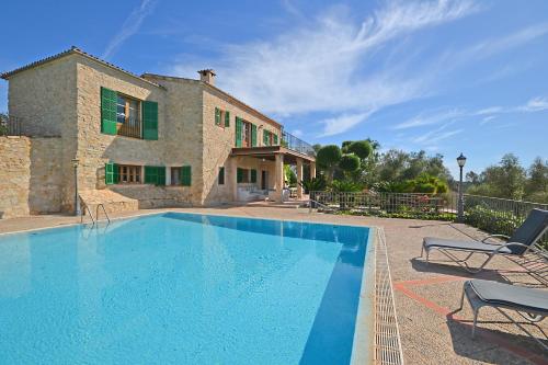 a villa with a swimming pool in front of a house at March in Petra
