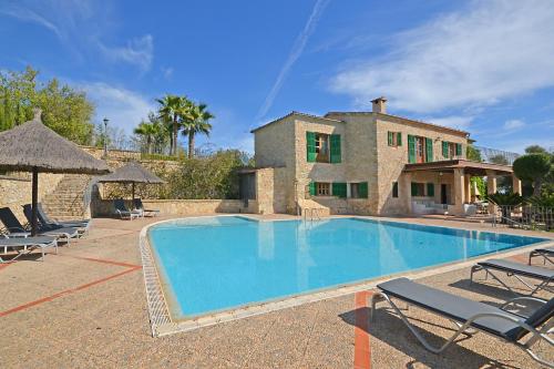 a large swimming pool in front of a house at March in Petra