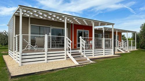 a home with a red and white house at Agriturismo Le Tese in Colà di Lazise