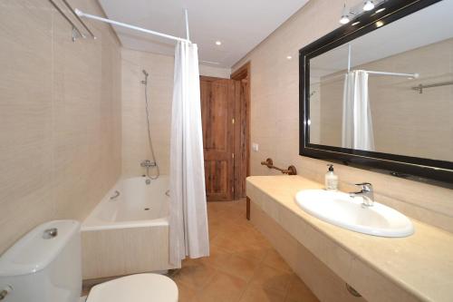 a bathroom with a tub and a sink and a toilet at March in Petra