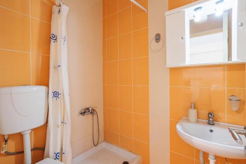 a bathroom with a shower and a toilet and a sink at Filiatra Cozy Cental Retreats with Balconies in Filiatra