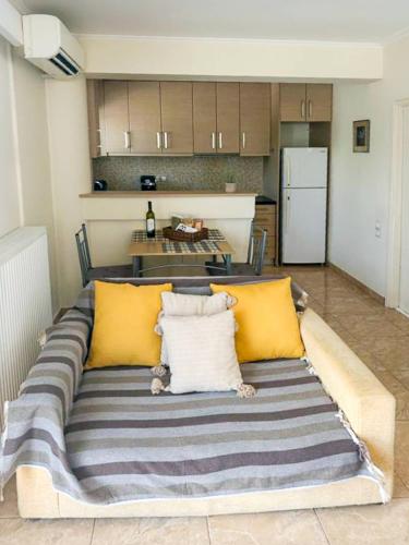 a couch with yellow pillows in a kitchen at Filiatra Cozy Cental Retreats with Balconies in Filiatra