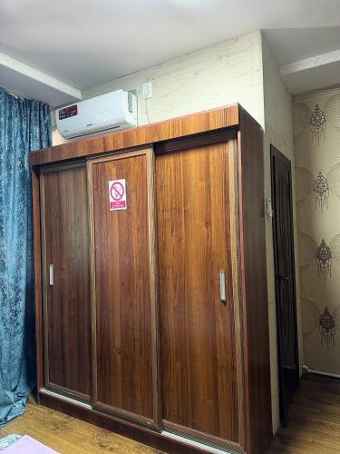 a pair of wooden cabinets in a room at Green house in Nukus