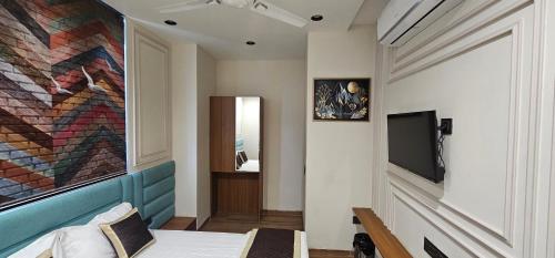 a room with a bed and a painting on the wall at Hotel Nexus Inn in Ahmedabad