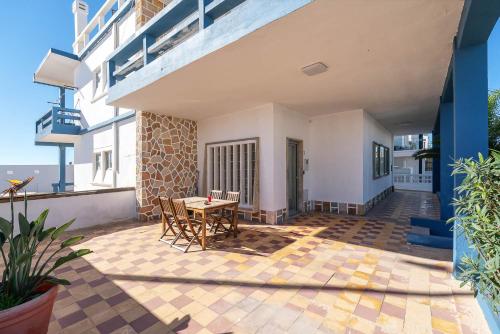 a patio with a table and chairs on a building at Blife Riamya private rooms in Faro