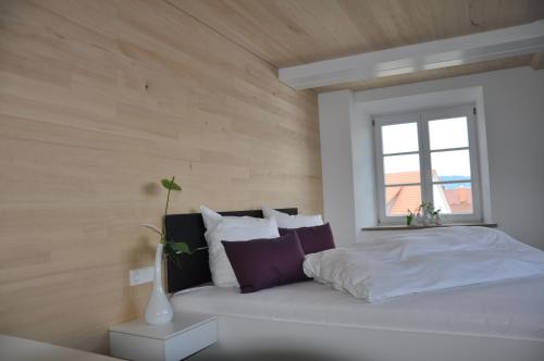 a bedroom with a white bed and a window at DIE KRONE - Hotel Garni in Kirchzarten