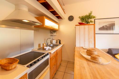a kitchen with a sink and a stove top oven at Appartement le Capitaine pour 4 personnes in Cap-Ferret