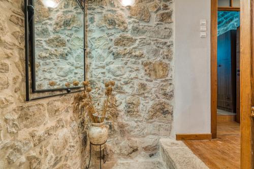 a stone wall in a hallway with a vase at Medieval Villa Philoxenia in Kalamoti