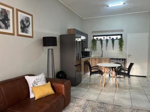 a living room with a couch and a table at Greenlee Lifestyle Apartment - One bedroom in Sandton
