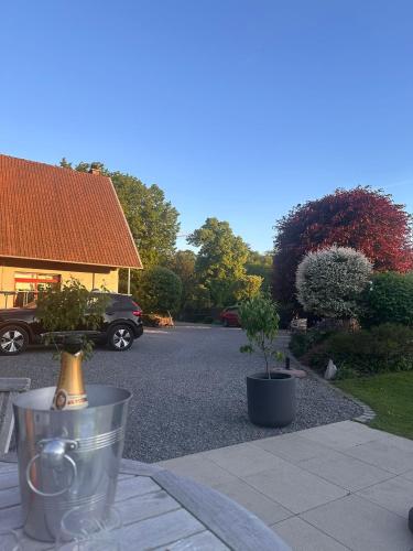 a parking lot with two potted plants and a car at Au Temps de Spa - La Tour du Tonnelet in Spa