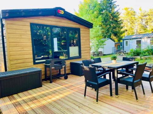 a patio with a table and chairs on a deck at Waldcamping Brombach in Pleinfeld