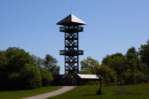 a large clock tower in the middle of a field at Au Temps de Spa - La Tour du Tonnelet in Spa