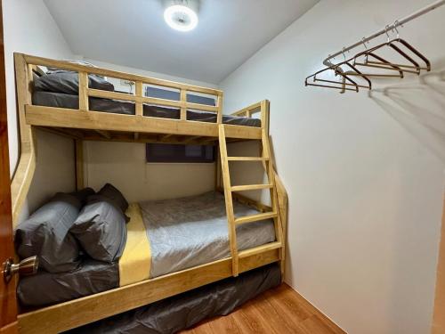 a bunk bed room with two bunk beds and a ladder at The 19th Transient House in Solano 1 in Solano