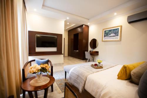 a hotel room with a bed and a table at Alhamra Hotel in Mardan