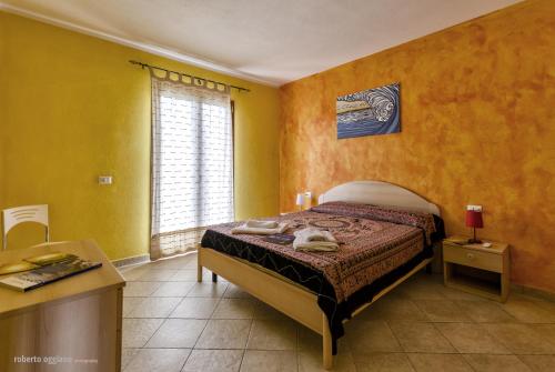 Кровать или кровати в номере Residenze L'Isola Surf House