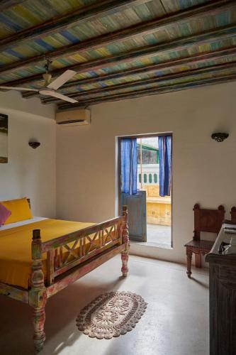 a bedroom with a bed and a large window at Antic Guesthouse - Galle Fort in Galle