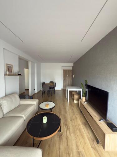 a living room with a couch and a table at Stylish 2 bedroom apartment in Limassol in Limassol