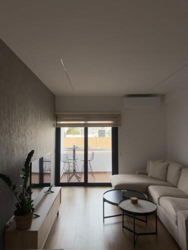 a living room with a couch and a table at Stylish 2 bedroom apartment in Limassol in Limassol