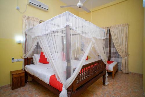 a bedroom with a bed with a canopy at Madoldu Eco Resort in Ahangama