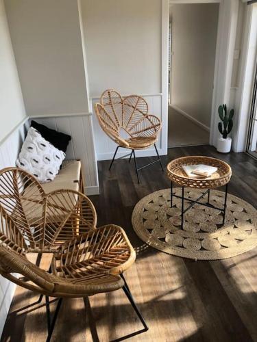 a living room with three chairs and a couch at Armara Views in Orange