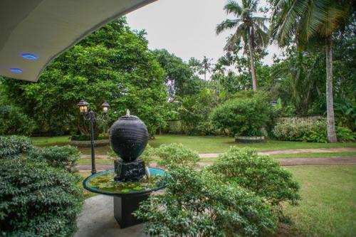a vase sitting on a table in a garden at Madoldu Eco Resort in Ahangama