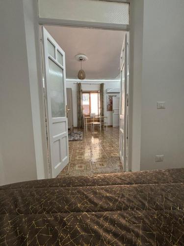 a bedroom with a door open to a living room at Casa di Anna in Carini