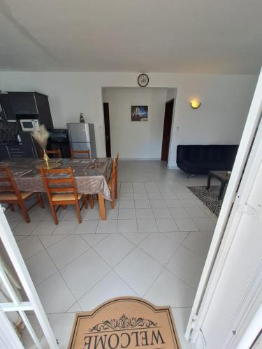 a dining room and living room with a table and chairs at Soleil Vacances Loisirs in Flic-en-Flac