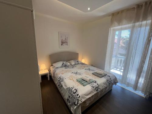 a bedroom with a bed and a window at Rakovica Centar in Belgrade