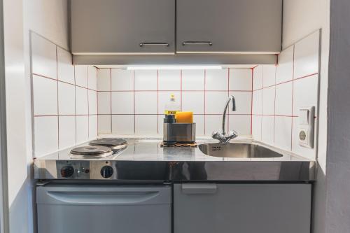 a small kitchen with a sink and a stove at Im Herzen von Bad Ischl #1 in Bad Ischl