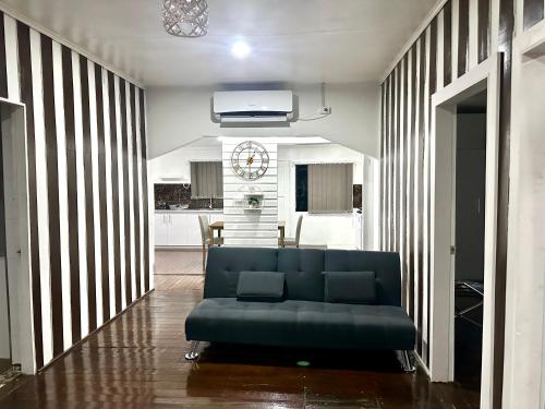 a living room with a blue couch in the middle at Large 3bdr Holiday Home Great Location Labasa Jumanzuls Abode in Labasa