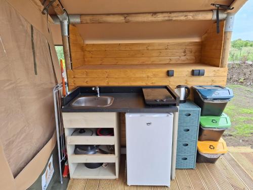 a kitchen in the back of a camper van with a sink at Delfino Tuscany Resort in Marina di Cecina