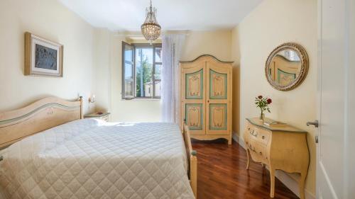 a bedroom with a bed and a mirror and a door at VILLA CAPPELLETTI 16&2, Emma Villas in Cesi